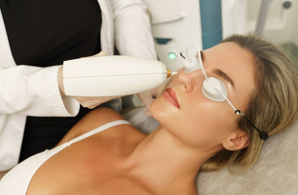 A woman receives IPL treatment for dry eye from an optometrist